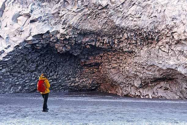 istock Hiker Admiring Basalt Columns on Vik Beach in Iceland 513045128