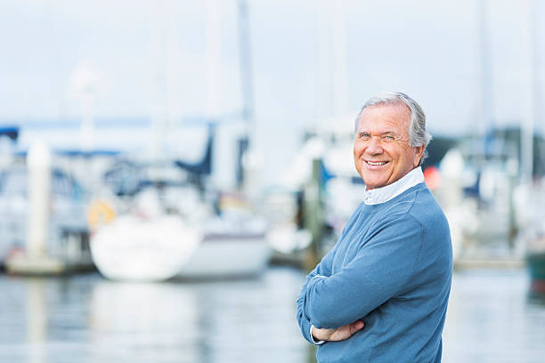 istock Senior man at marina, standing with arms folded 513045786