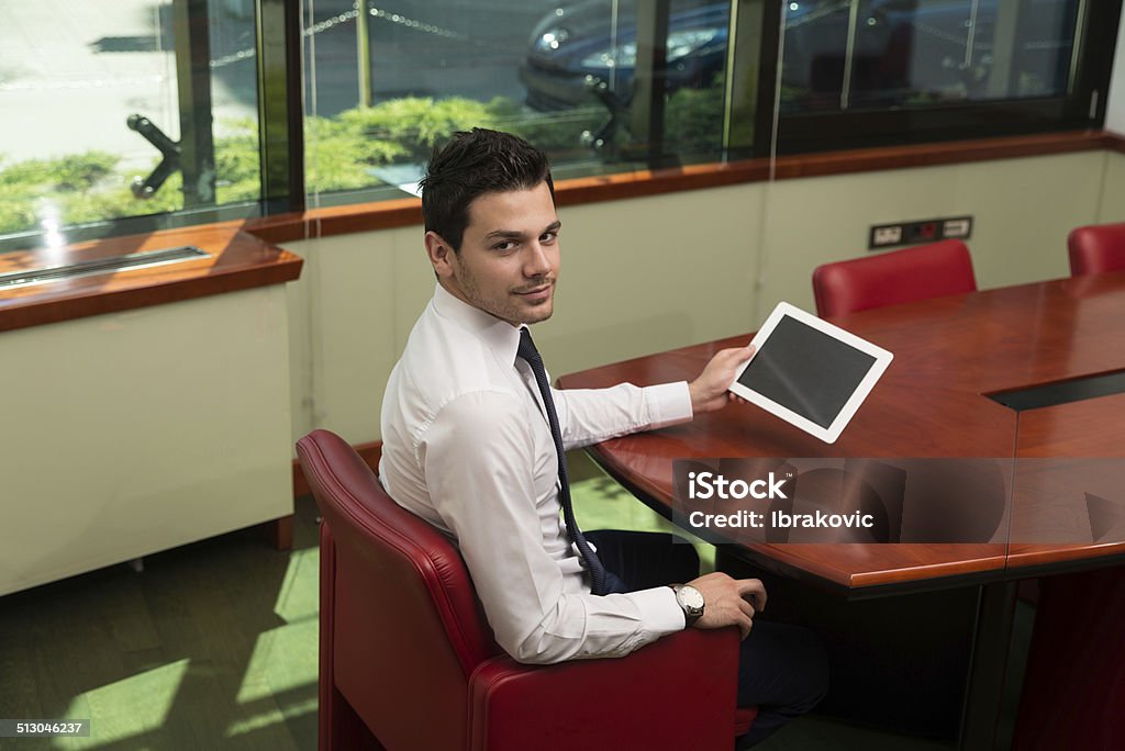 Businessman On A Break With His Touchpad Portrait Of A Young Business Man Using A Touchpad In The Office Adult Stock Photo