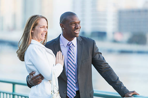 istock Happy multi-racial couple laughing, man wearing suit 513046378