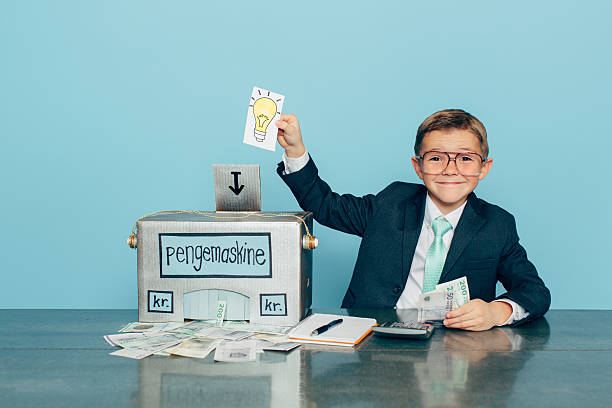 istock Business Boy Puts Ideas in Machine and Makes Danish Money 513047142