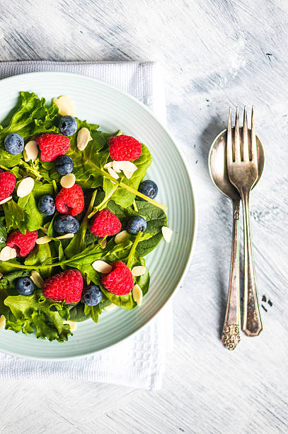 istock Green salad with berries and almonds 513047165