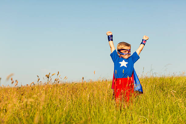 istock Young Boy Dressed as Superhero Imagines Flying 513047208