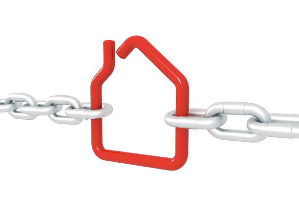 istock Red house symbol blocked with metal chains 513047493