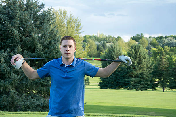 Golfer holding his club on shoulder at the golf course 