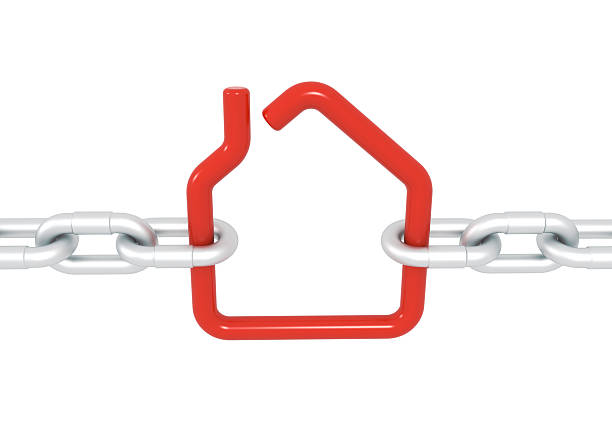 istock Red house symbol blocked with metal chains 513047881