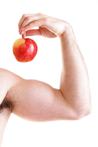istock Athletic sexy male body builder holding red apple 513047910