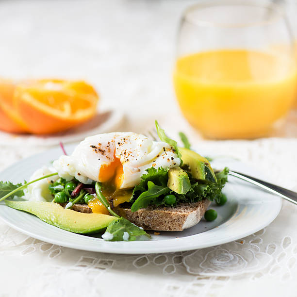 istock Toast and Poached Egg with Green Salad, Avocado and Peas 513048100