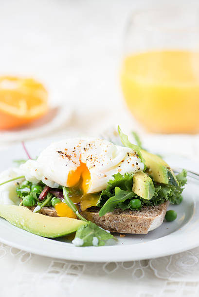 istock Toast and Poached Egg with Green Salad, Avocado and Peas 513048136