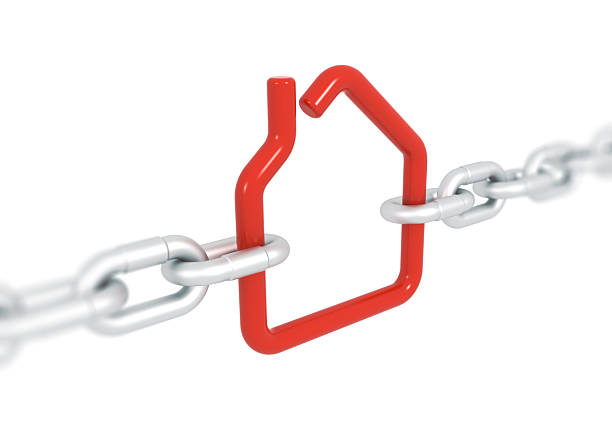 istock Red house symbol blocked with metal chains 513048241
