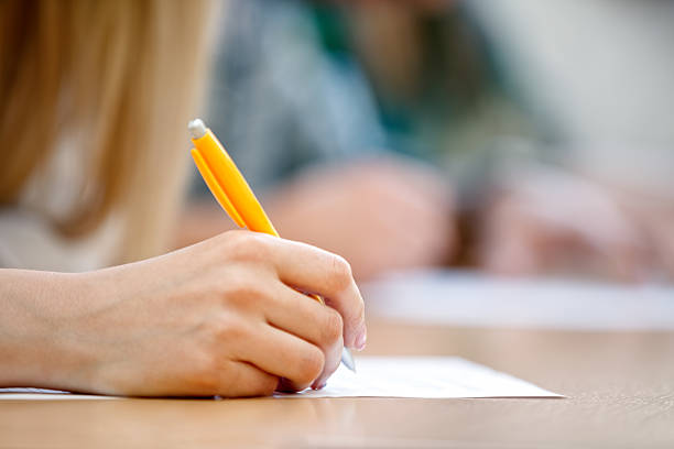 Writing Hand Stock Photo - Download Image Now - Educational Exam, Writing - Activity, Handwriting - iStock