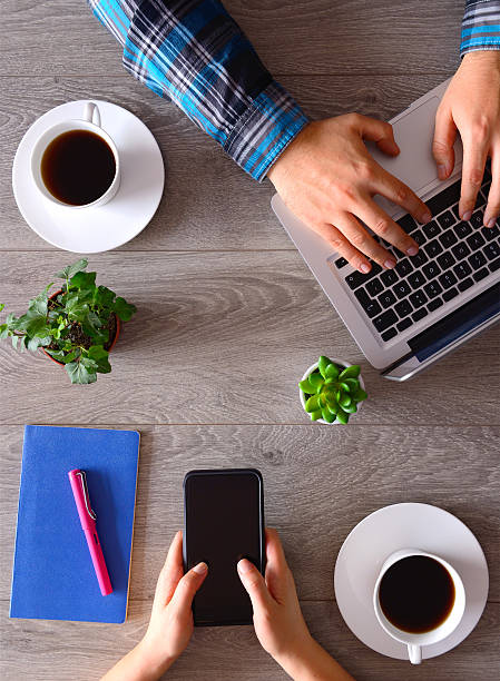 istock People using smartphone and laptop on desk 513049564