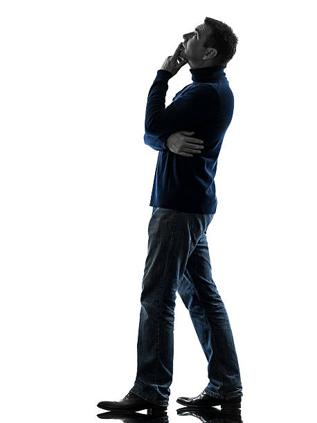 istock man looking up pensive silhouette full length 513051137