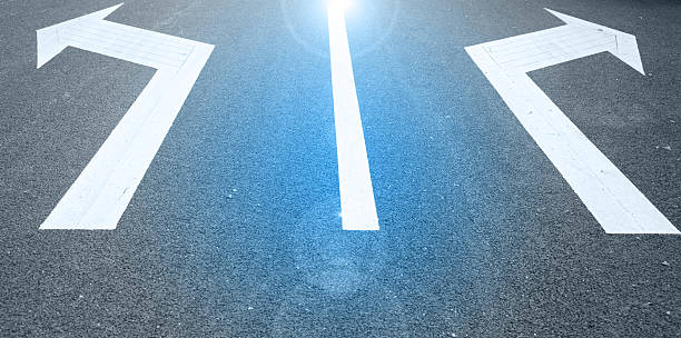 istock white painted arrow on black asphalt road 513051755