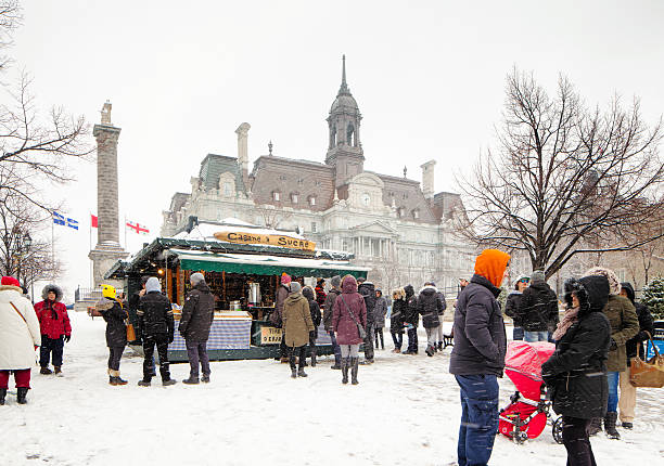 Small tourist crowd brave snowy weather to visit Old Montreal Montreal, Canada - February 6, 2016: Small tourist crowd brave snowy weather to visit Old Montreal's place Jacques-Cartier. Many are stopping at a small maple shop to order warm cider and hot chocolate. place jacques cartier stock pictures, royalty-free photos & images