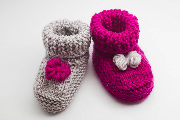 istock Couple knitted bootees to newborn 513053262