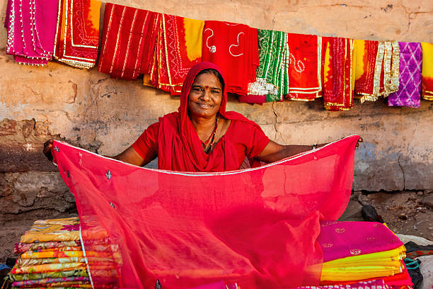 istock Indian woman selling colorful fabrics 513056236