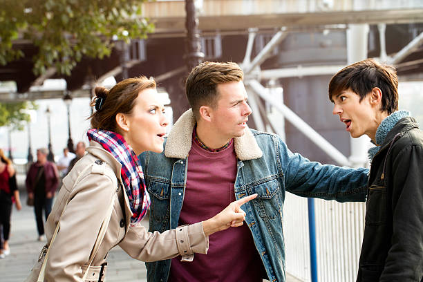 istock Two women fighting each other while man keeps them apart 513056480