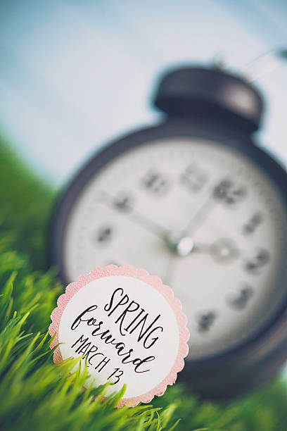 istock Clock in grass with reminder for Daylight Savings Time 513058286