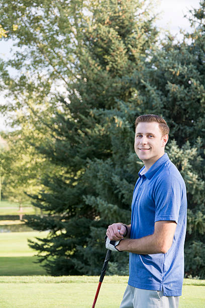 istock golfer smiles while playing game of golf 513058490