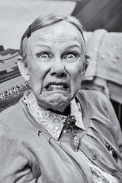 Female Making a Scary Face Elderly woman making a scary face at the camera ugly old women stock pictures, royalty-free photos & images