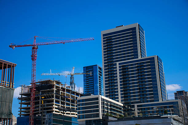 Construction Cranes Build a New Austin Texas 2016 Construction Cranes Build a New Austin Texas 2016 As New Condos go up one of the newest condominiums in Austin Texas. Construction site with multiple cranes and blue sky to work all day  construction skyscraper machine industry stock pictures, royalty-free photos & images