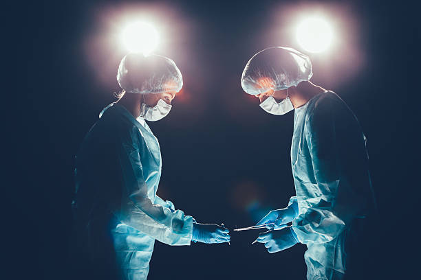 istock Medical team  hospital performing operation. Group of surgeon at work 513064672