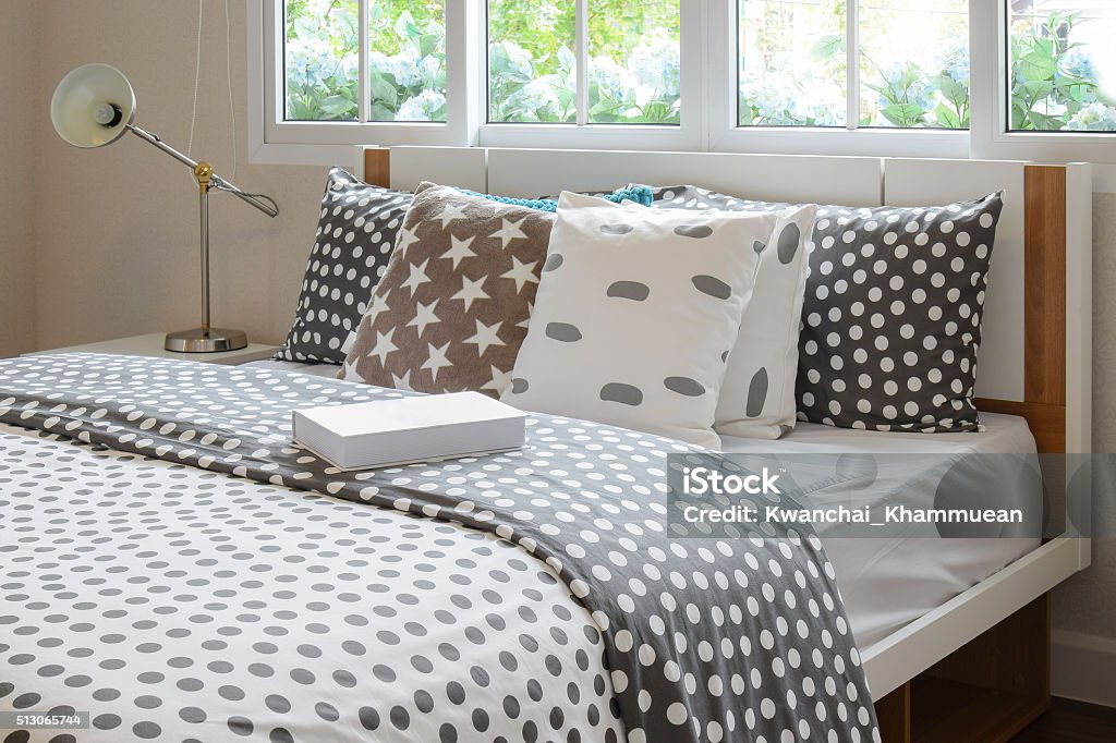 bedroom interior with polka dot pillows on bed bedroom interior design with polka dot pillows on bed and decorative bedside table lamp. Bedding Stock Photo