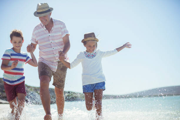 istock Family running in water on beach 513066513