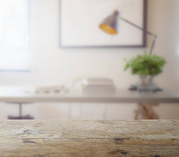 wooden table top with blur of modern working table stock photo