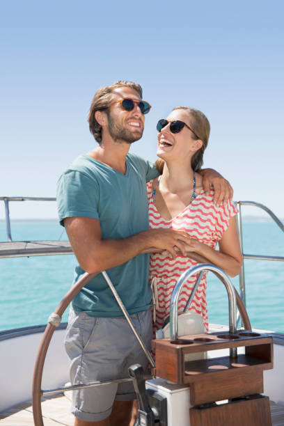 istock Couple steering boat together 513067693