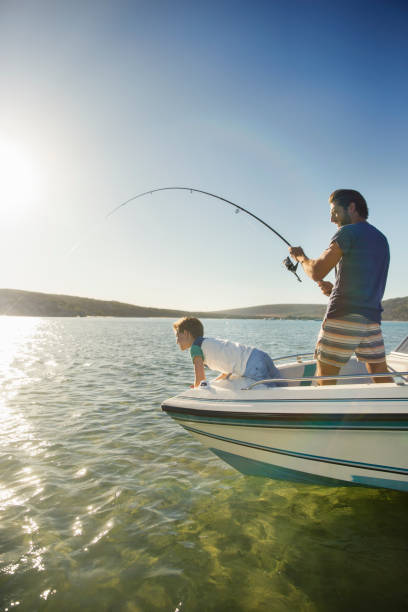 istock Father and son fishing on boat 513067945