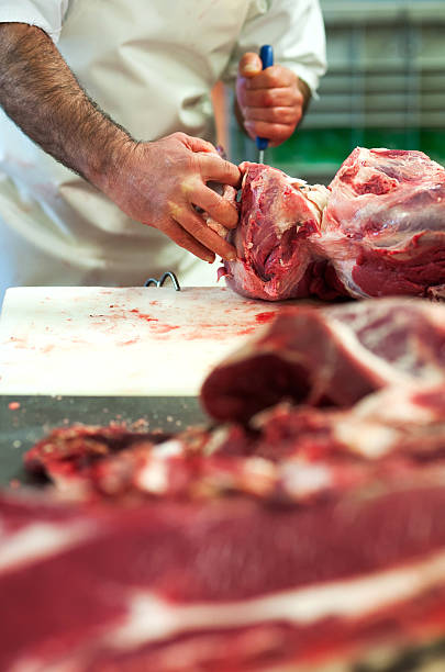istock Butcher cutting up raw meat in a butchery 513068022
