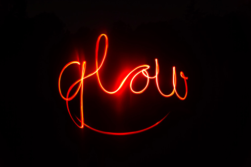 the word glow written with a flashlight.