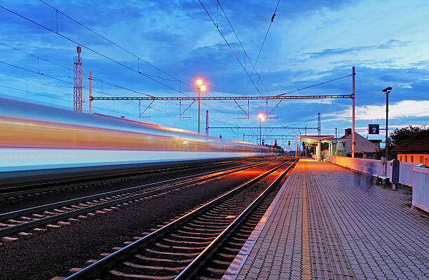 istock Train station in motion blur at night, railroad 513071297