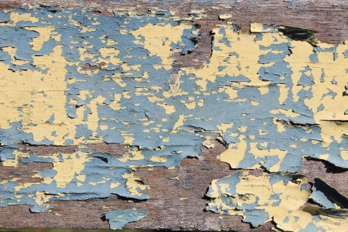 Flaking, sun-baked paint on an antique horse cart in Vermont