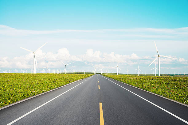 istock road and windmill power plants 513073425