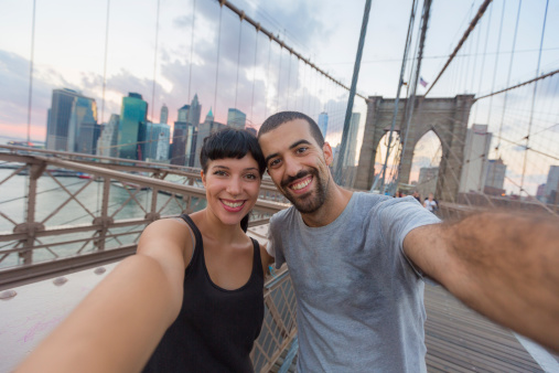 Young Couple Taking Selfie on Brooklyn Bridge