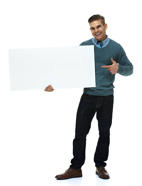 istock Cheerful smart casual man holding placard & pointing 513075675