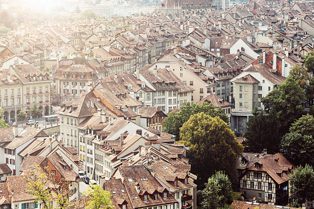Architecture, roofs and landmarks in City of Bern, Switzerland Desaturated photo from high angle point of view of Swiss capital Bern from hills nearby bern photos stock pictures, royalty-free photos & images