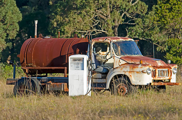 Rusty tanker, skeleton driver and bowser stock photo