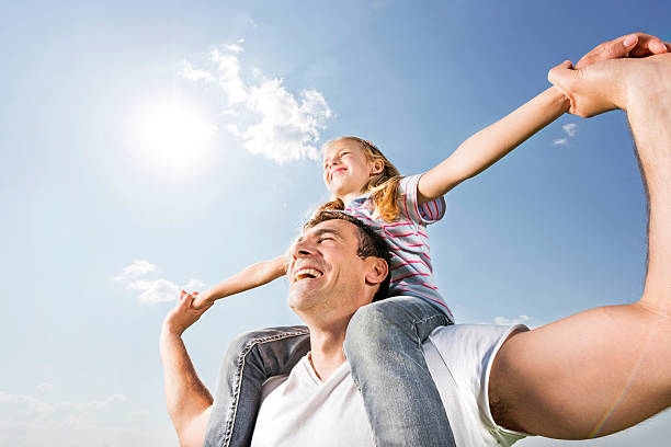 istock Playful father and daughter against the sky. 513077211
