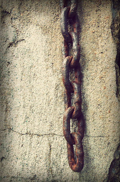 istock Rusty old chain on the cement background,retro vintage style 513077975
