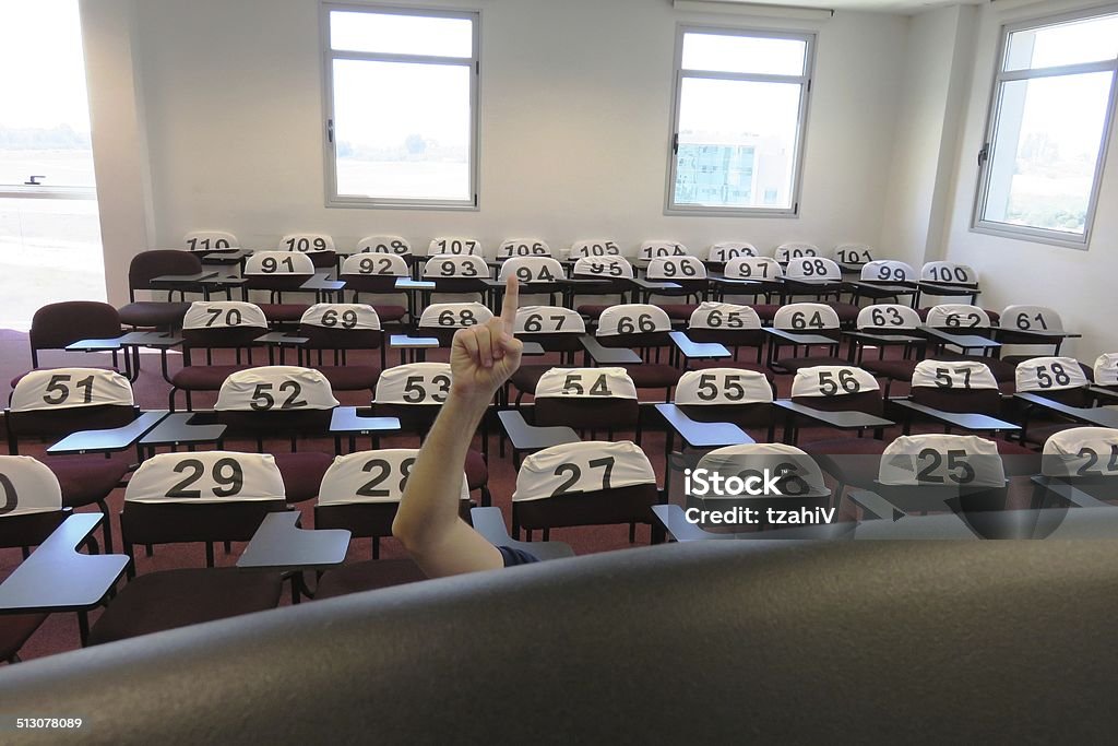 Classroom A classroom is empty except for one curious student Hand Raised Stock Photo