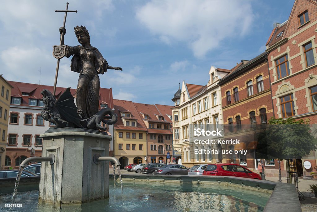 Kahla Thuringia Germany - Market place fountain Kahla, Germany - September 9, 2014: the fountain at the market place in Kahla - Thuringia, Germany. Kahla is located in the near of the Leuchtenburg. Its a new restaurated small city with a very nice colorful old town. Some cars parking at the market place and some people sitting in small restaurants.  Kahla is known for his famous porcelain manufacture. City Stock Photo