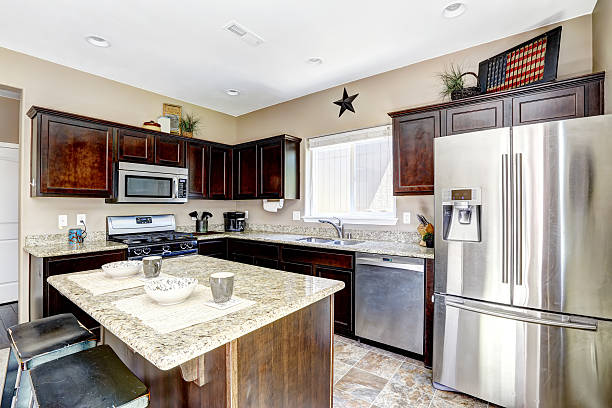 istock Dark brown cabinets with granite tops. Kitchen room interior 513099153
