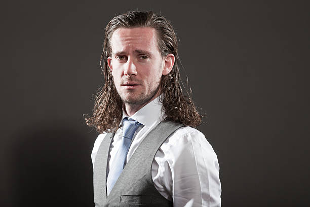 istock Young man long hair expressive face wearing suit and tie. 513099671