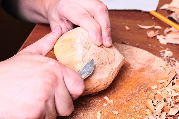 istock carpenter hand carving wood 513100229