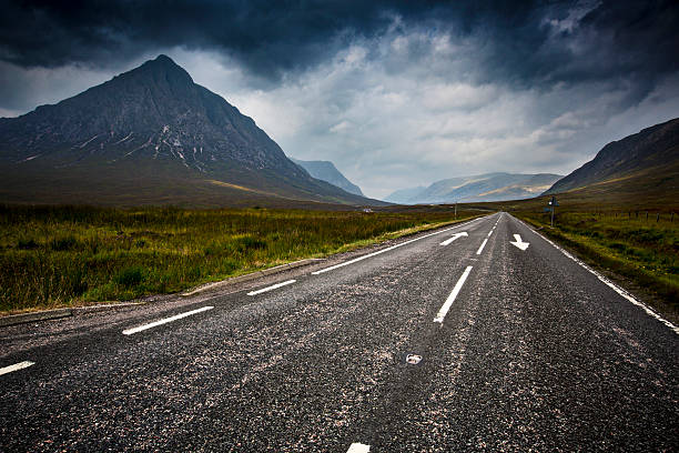 Road in Glencoe Cloudy day on a road in Glencoe, Scotland - UK glen etive photos stock pictures, royalty-free photos & images