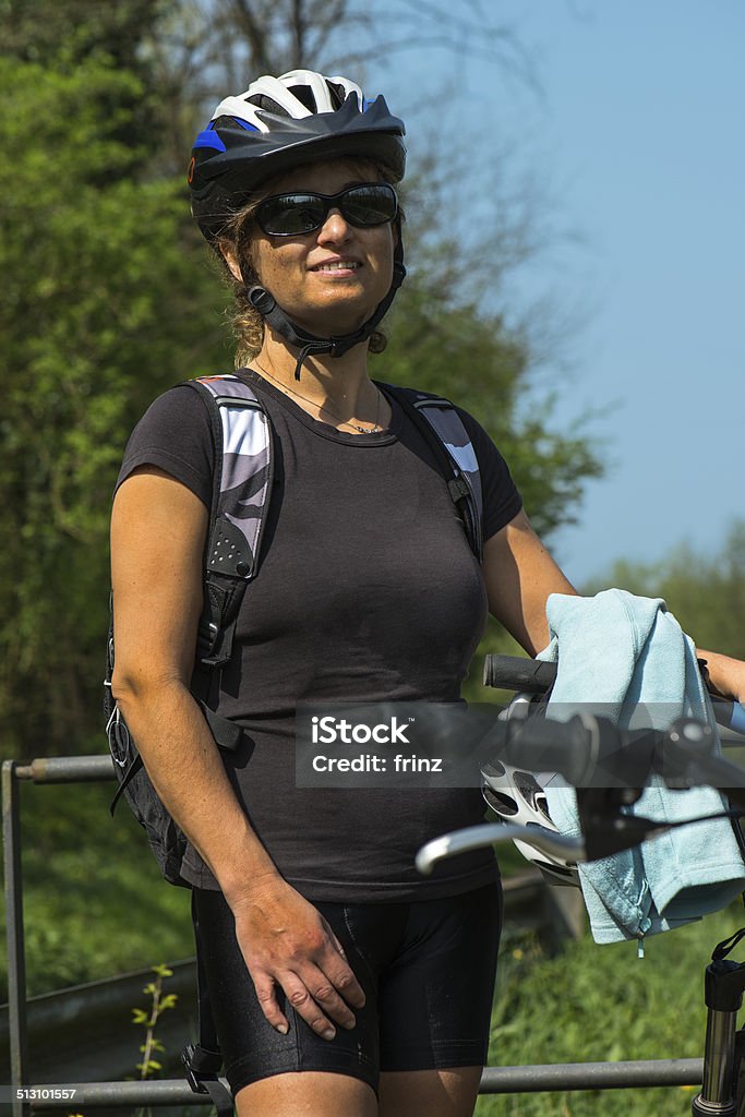 tired middle aged cyclist a  tired middle aged  woman ciclyst Activity Stock Photo